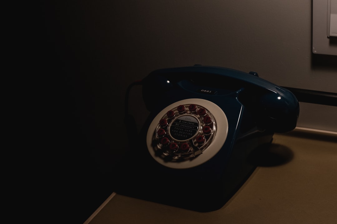 a green pay phone sitting on top of a table
