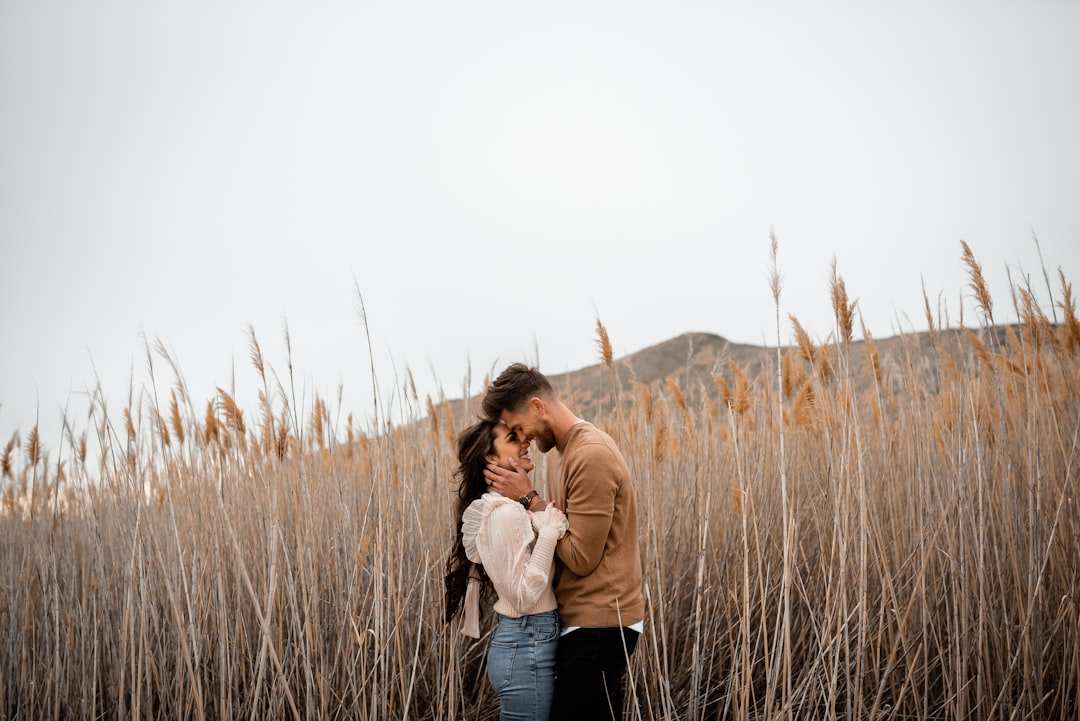 A man and a woman standing in a field